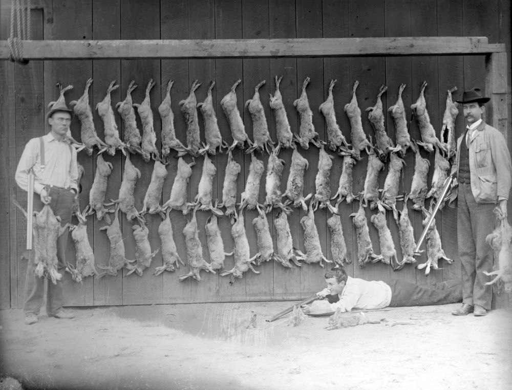 hunters with their kill (rabbit?)